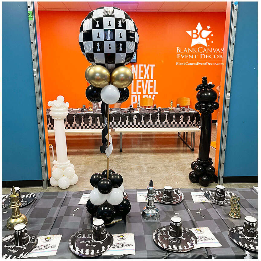 Checkered Chess Centerpiece with a view of the 2 large chess Piece Balloon Sculptures