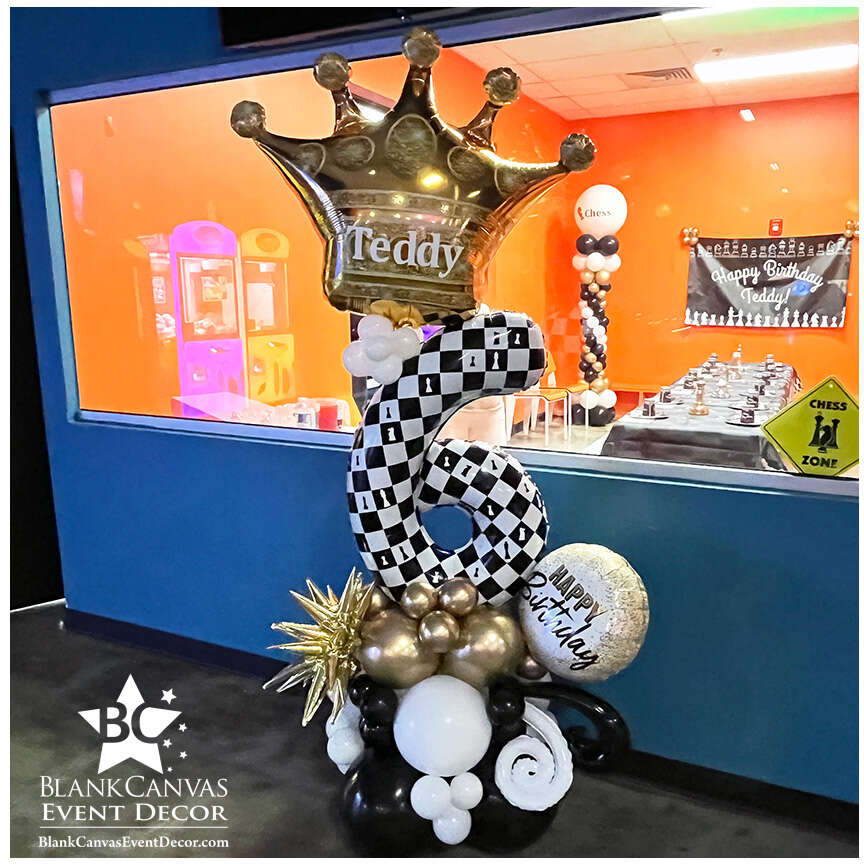 Chess Theme 6th Birthday Balloon Billboard with a large gold crown on top with Teddy written on it in vinyl and chess pieces in the checkerboard print of the number 6