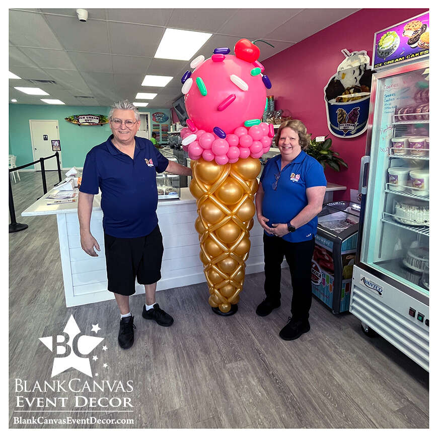 7 foot Ice Cream Balloon Sculpture with the Ice Cream Hut Owners standing on each side